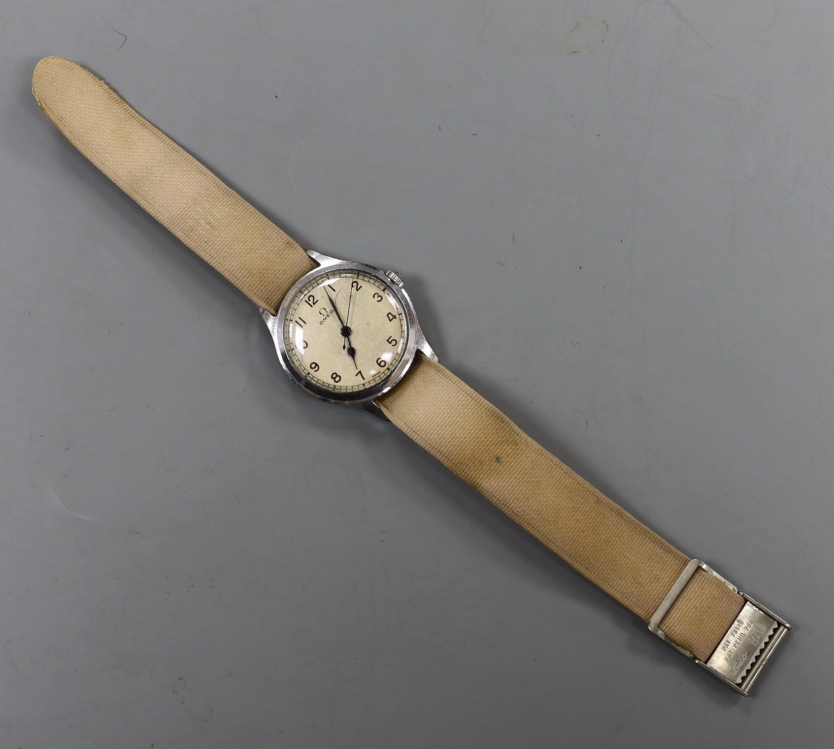 A gentleman's early 1940's stainless steel Omega manual wind wrist watch, on associated fabric strap.